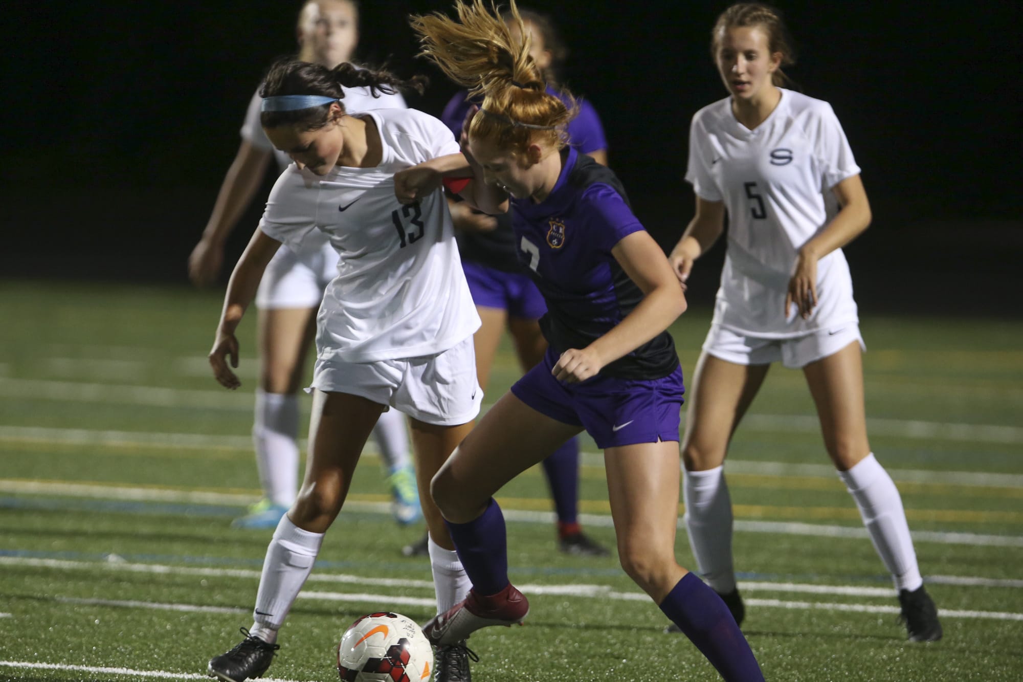 Skyview's Olivia Madden (13) and Columbia River's Reagan Griffith (7) fight for the ball. Skyview beat Columbia River, 1-0, in the the season opener on Sept. 4, 2018 at Columbia River High School in Vancouver. (Randy L.