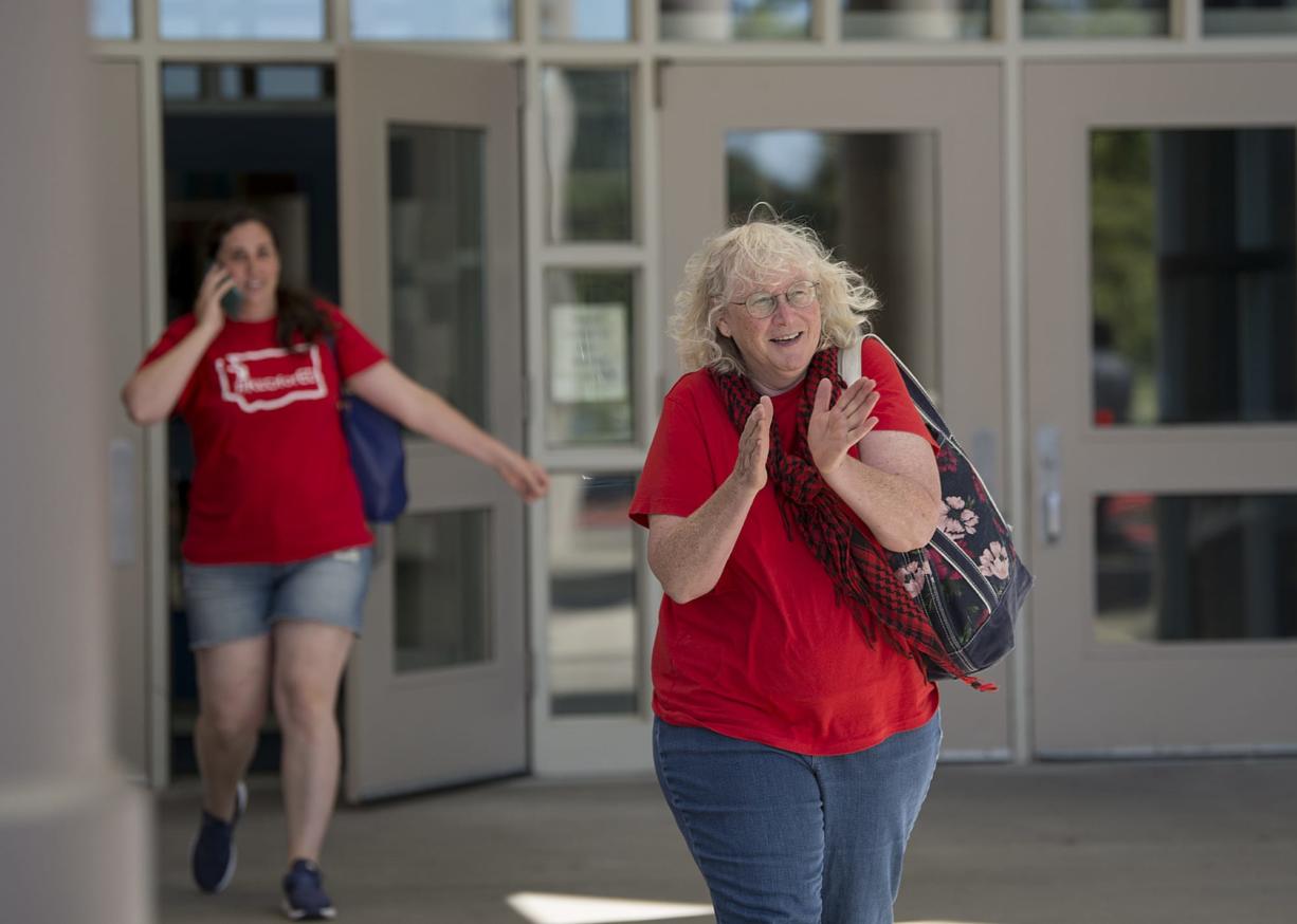 School nurse Marcia Schneider, right, shows her enthusiasm for the new contract after voting with fellow members of the Vancouver Education Association at Skyview High School on Tuesday afternoon, Sept. 4, 2018.