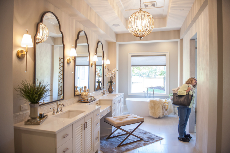 Judy Nakashima examines the bathroom of The Black Pearl at the Parade of Homes at the Camas Meadows Golf Course on Friday. The event opened Friday and will run every day until Sept. 23, except for Mondays and Tuesdays.