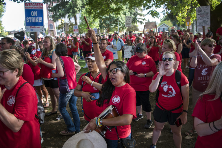 Angie Floyd, teacher at Pioneer Elementary School, center, cheers on the speakers during a rally at Esther Short Park on Friday afternoon, Sept. 7, 2018. Thousands of teachers from districts who are still on strike and community supporters showed up for the rally.