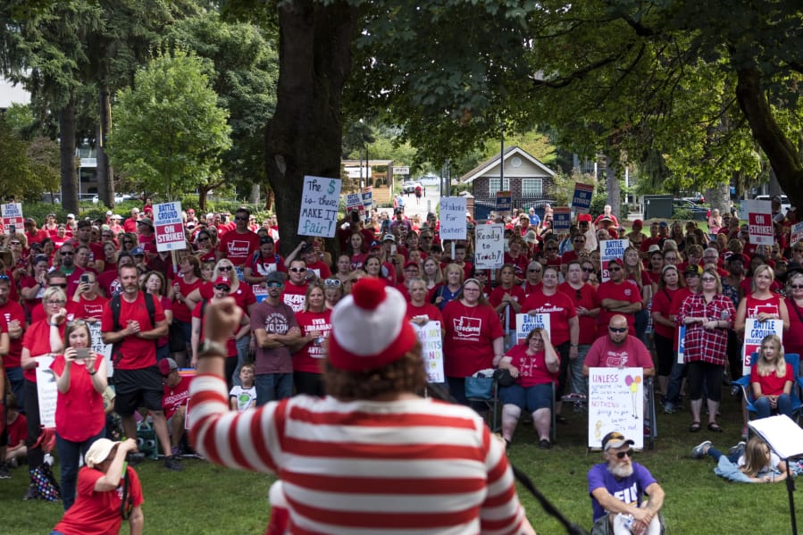 Becky Broyles, teacher at River Homelink, speaks to a crowd of thousands of teachers and community supporters at Esther Short Park on Friday afternoon. Teachers capped off a second week of strikes with the rally.