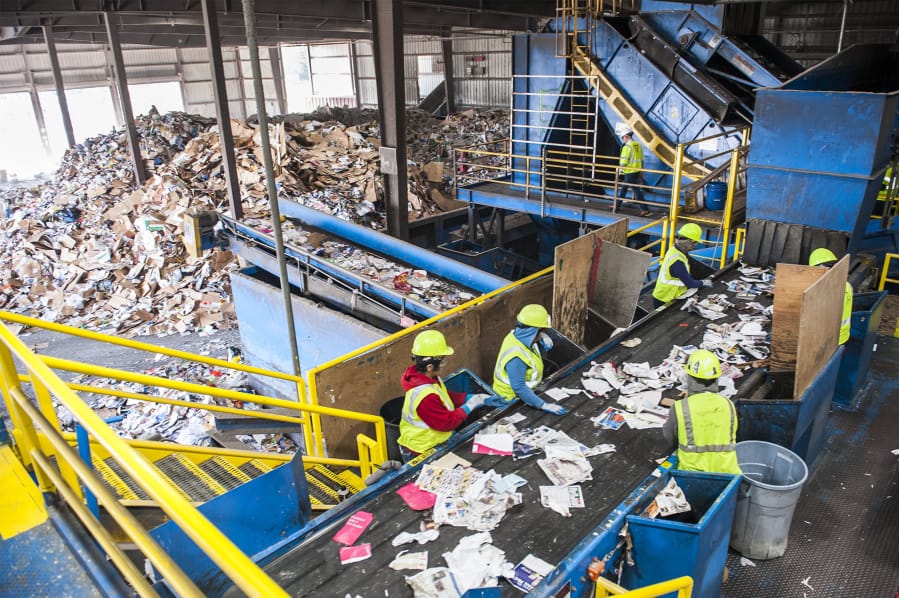 Line sorters comb through plastics and paper moving along a conveyor belt at Waste Connections Washington-Clark County material recycling facility on Northwest Lower River Road. The site processes tens of thousands of tons of recyclable materials every year, mostly from Clark County.