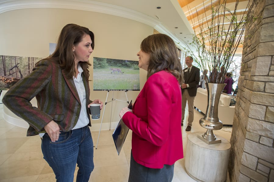 Rep. Jaime Herrera Beutler, R-Battle Ground, left, and Sen. Maria Cantwell, D-Wash., chat Monday morning at the Ed and Dollie Lynch house while celebrating with Columbia Land Trust supporters for their work preserving forests surrounding Mount St. Helens.