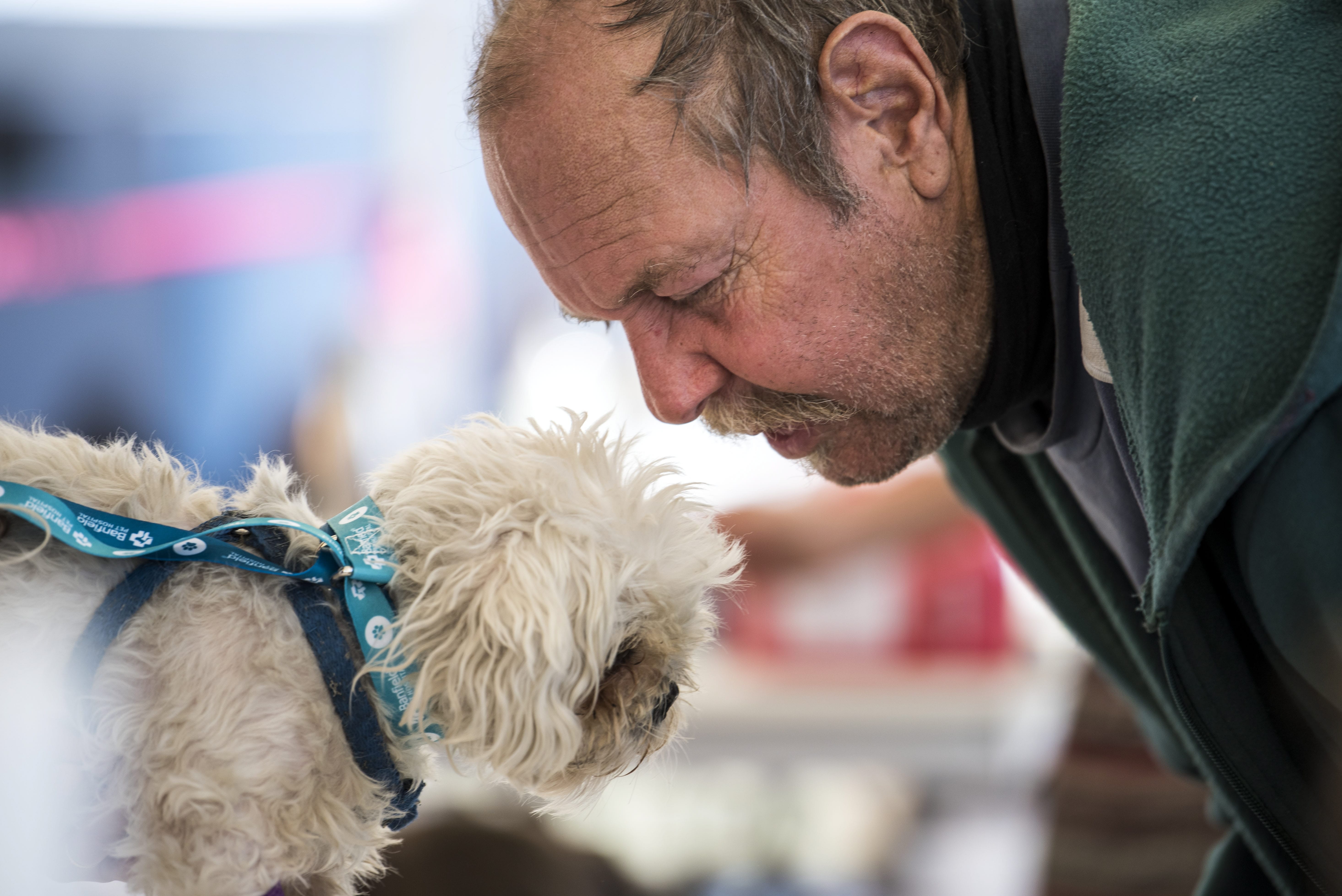 J.C. Ingram of Vancouver leans in to comfort his four-year-old dog Fritzy during the free pet clinic at Open House Ministries on Thursday afternoon, Sept. 20, 2018.