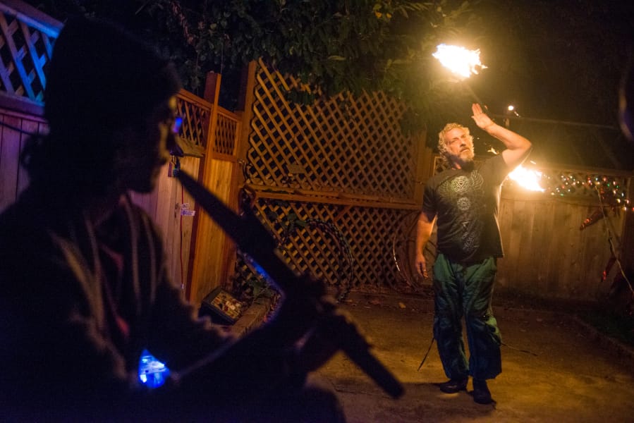 Michael Gorman dances with fire during a full moon community drum circle at Wattle Tree Place this past Saturday night. Wattle Tree’s future is uncertain; the block it sits on is being redeveloped, but the sisters who operate the business haven’t found an appropriate site for relocation.