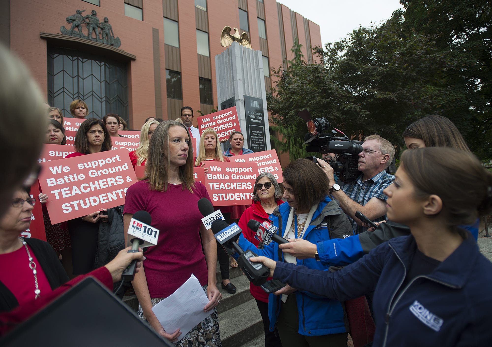 Marina Heinz, a fourth-grade teacher and vice-president of the Battle Ground Education Association, speaks to the media on the steps of the Clark County Courthouse before the injunction ruling Friday morning, Sept. 14, 2018.