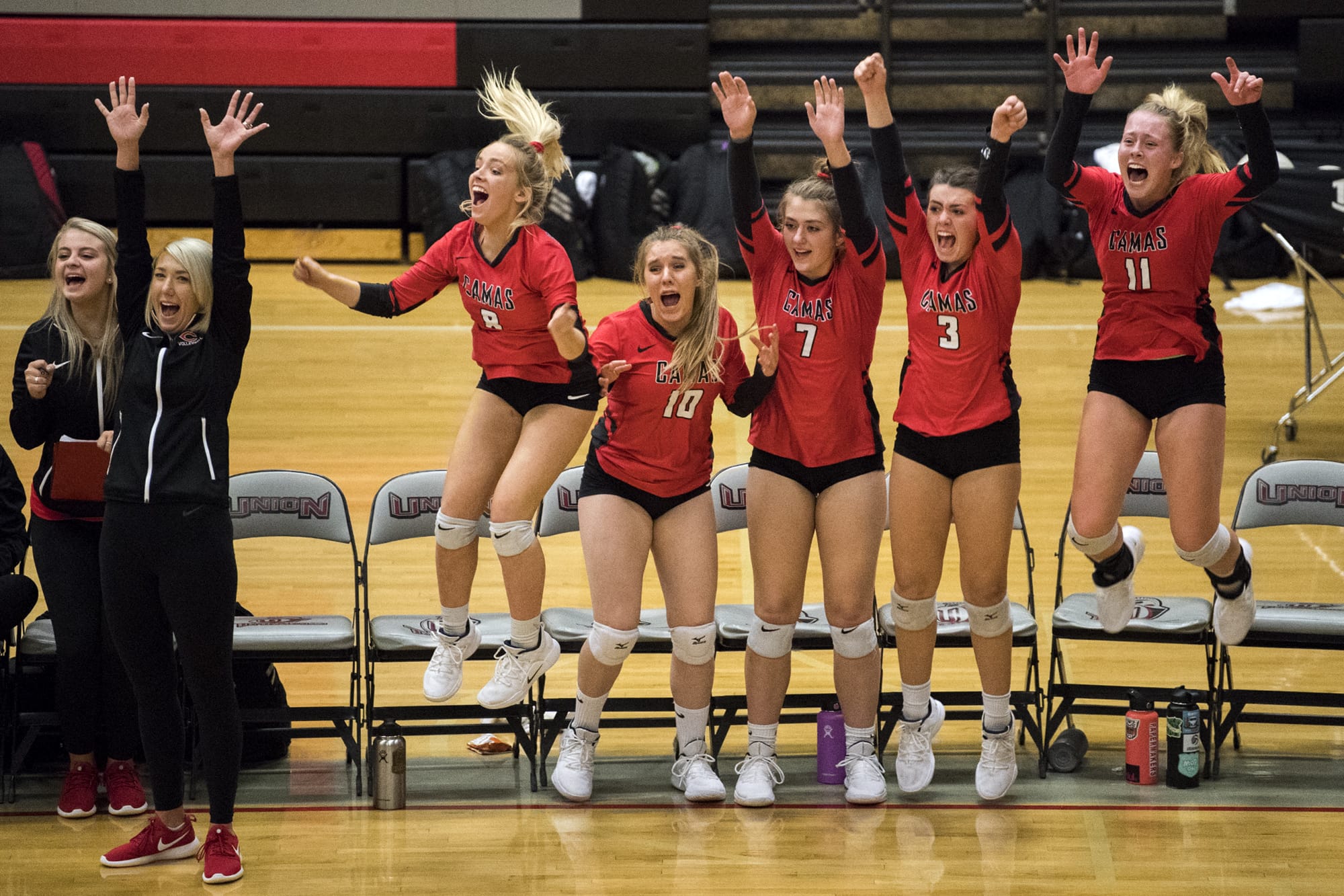 Camas celebrates their final point to win in four sets during the game at Union High School in Camas on Thursday, Sept. 20, 2018.