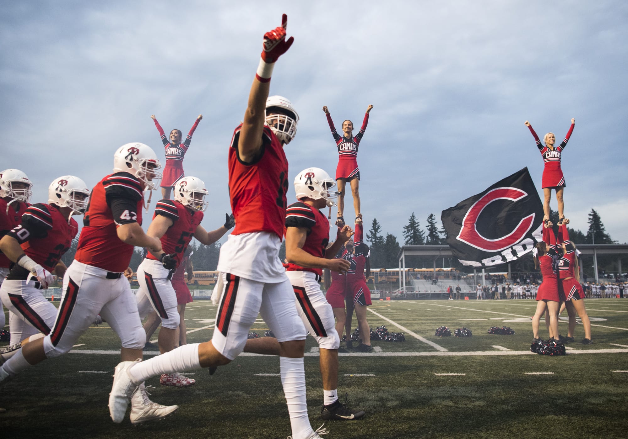 The Camas Papermakers run onto the field before Friday night's game against Bellevue at Doc Harris Stadium in Camas on Sept. 21, 2018.