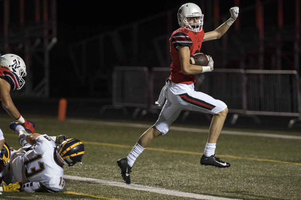 Camas' Jackson Clemmer (83) breaks away from Bellevue defense to score a touchdown during Friday night's game at Doc Harris Stadium in Camas on Sept. 21, 2018.