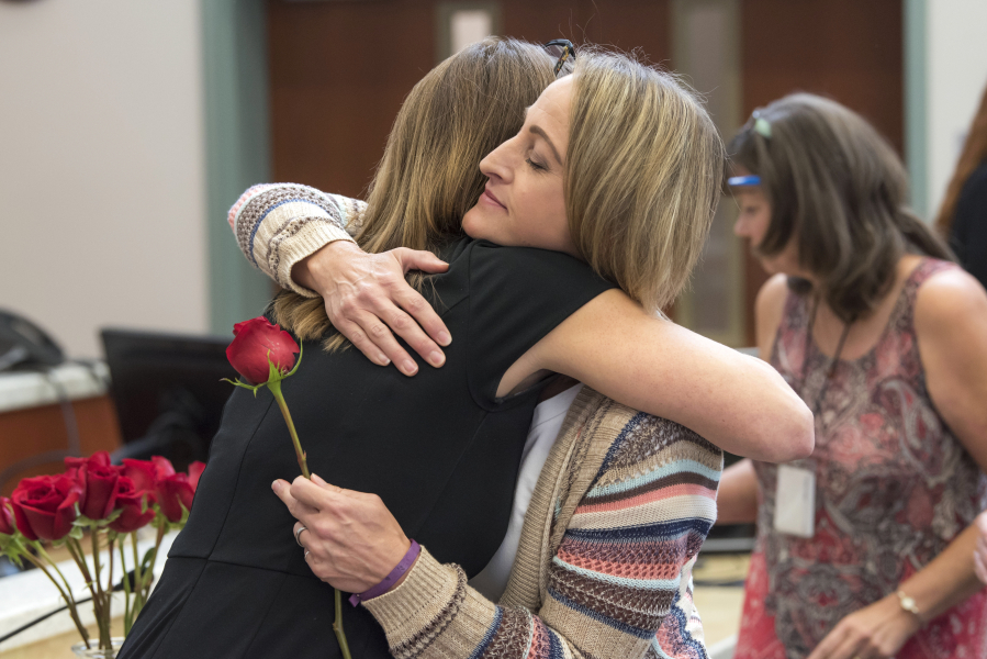 Victim Advocate Amy Harlan, left, and Brenda Eyman, whose sister, Janell Knight, was killed in 2016, embrace during a service honoring the National Day of Remembrance on Friday at the Clark County Public Service Center.