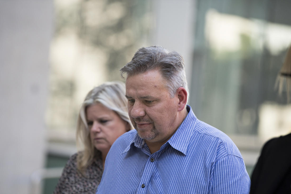 John Bishop and his estranged wife, Michelle Bishop, enter the James M. Carter and Judith N. Keep United States Courthouse in San Diego on Friday afternoon. John Bishop’s truthfulness was at issue during his hearing, which caused the judge to postpone his criminal sentencing until Monday.