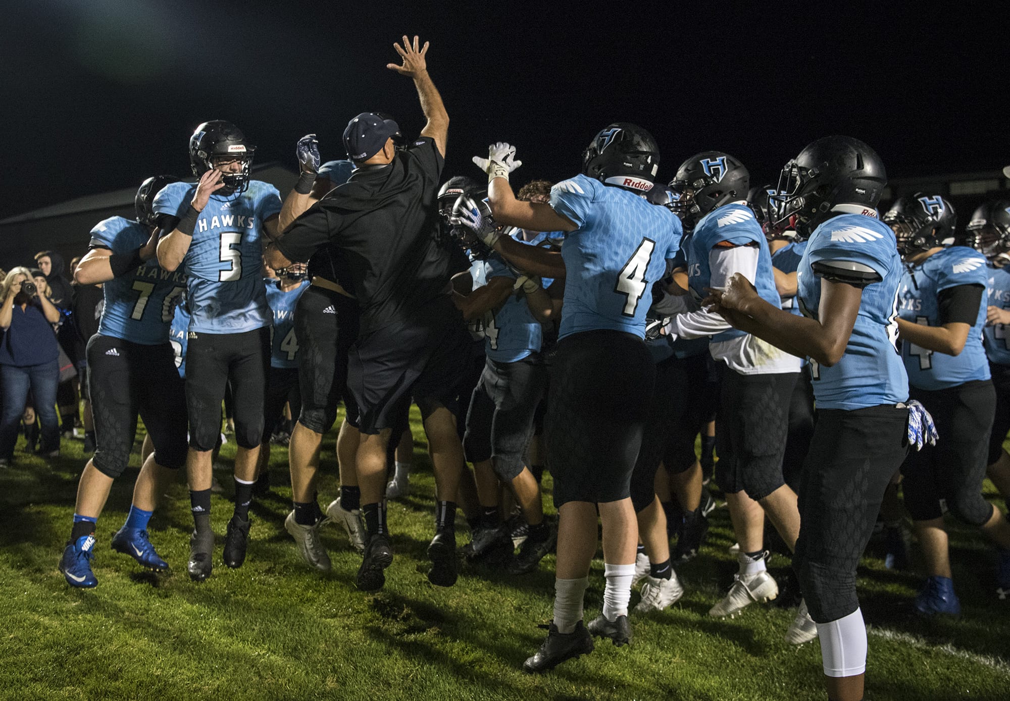 Hockinson coach Rick Steele celebrates the win over Woodland with his team after Friday night's game in Hockinson on Sept. 28, 2018. Hockinson won 42-27.