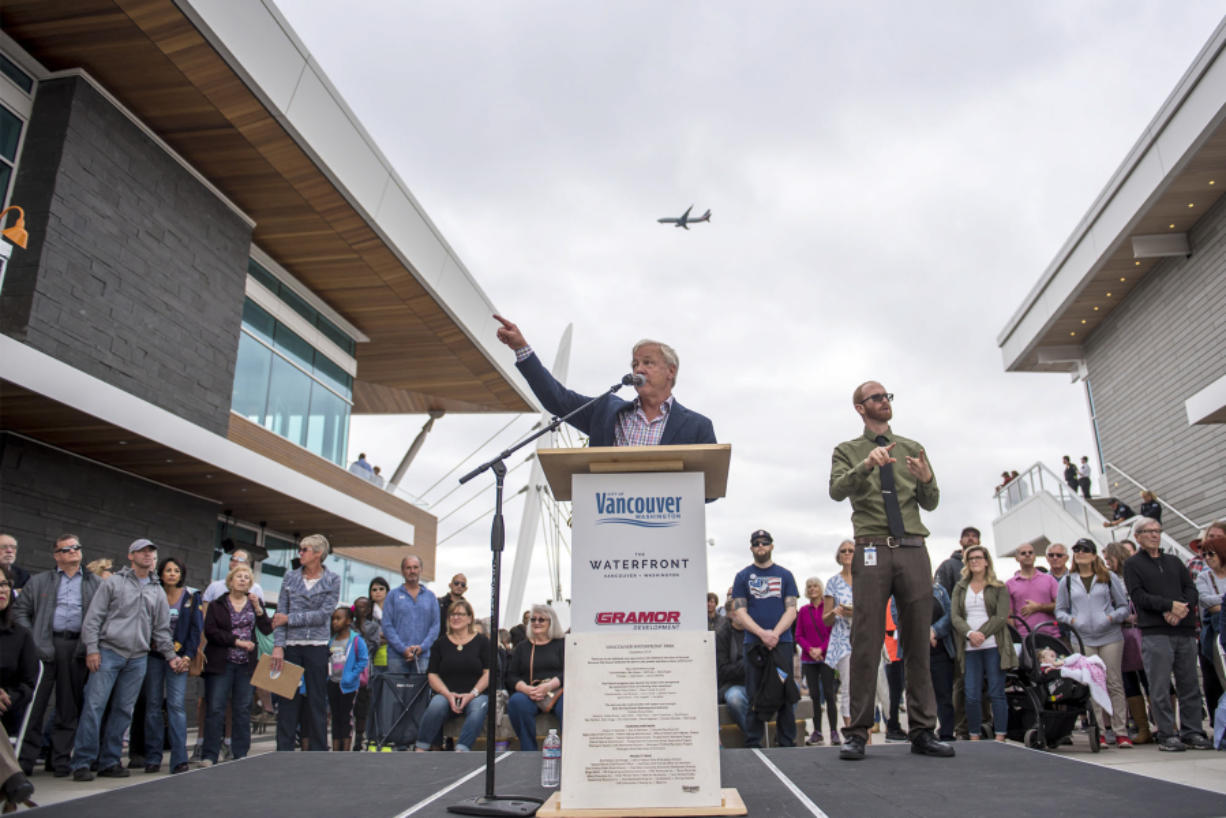 Barry Cain, owner of Gramor Development, speaks while a plane flies over head the Vancouver Waterfront Park grand opening on Saturday afternoon, Sept. 29, 2018.