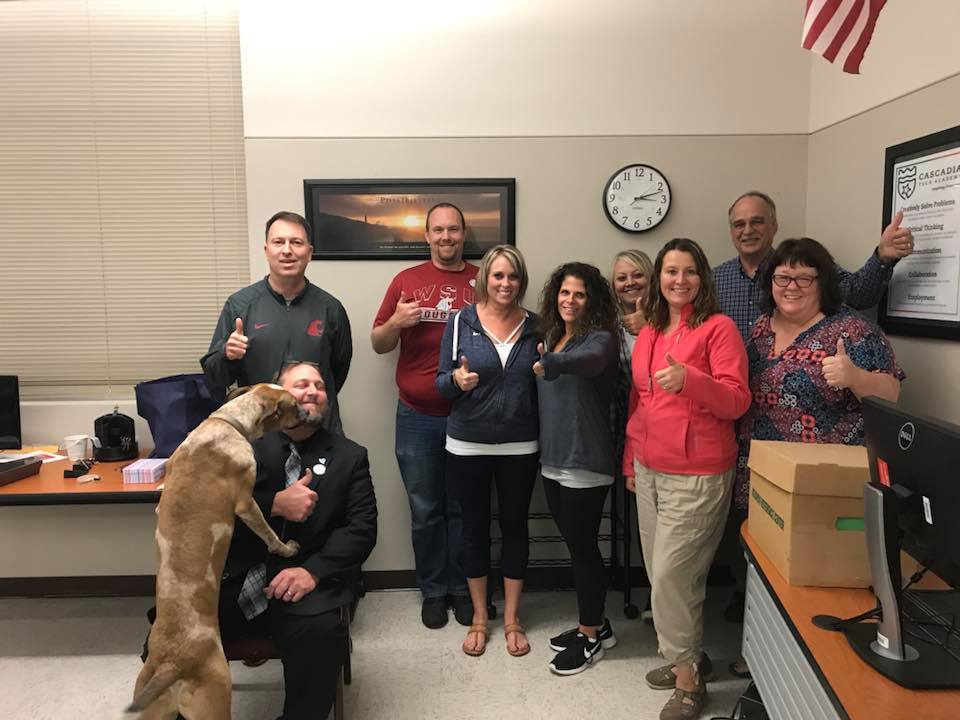 Negotiators pose for a celebratory photo early Sunday morning after reaching a tentative contract agreement in Evergreen Public Schools. If the deal is ratified Sunday night by the Evergreen Education Association, classes in the district will begin Monday.