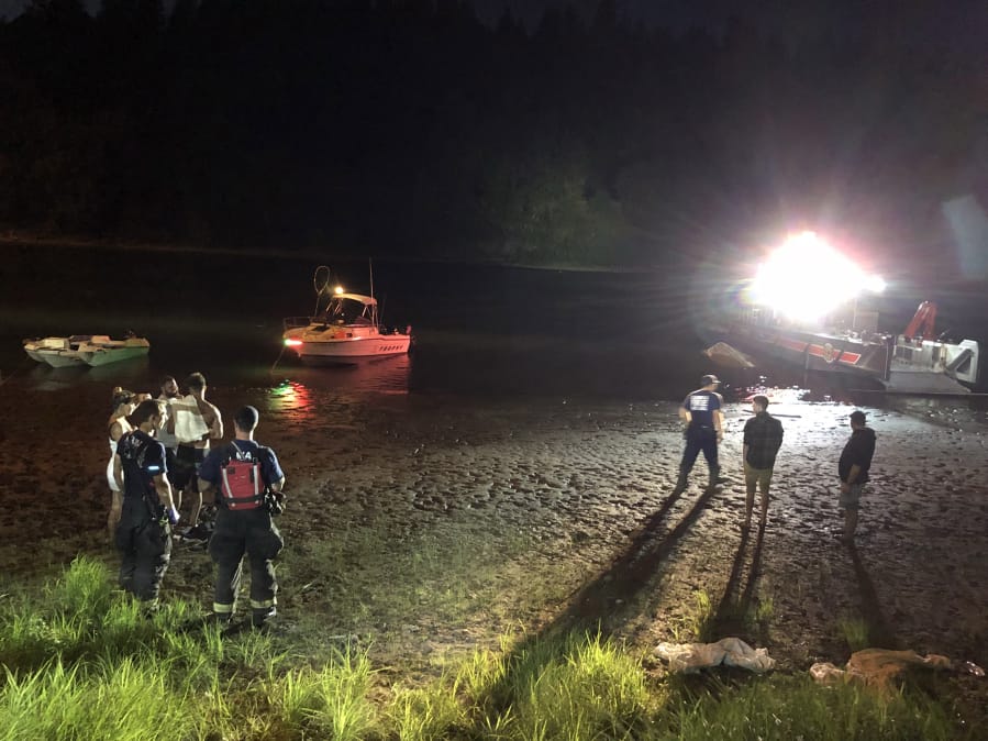 Police and fire crews respond after two boats collide under the Camas Slough bridge Sunday evening. One boater was killed, according to the Camas-Washougal Fire Department. Two others were injured.