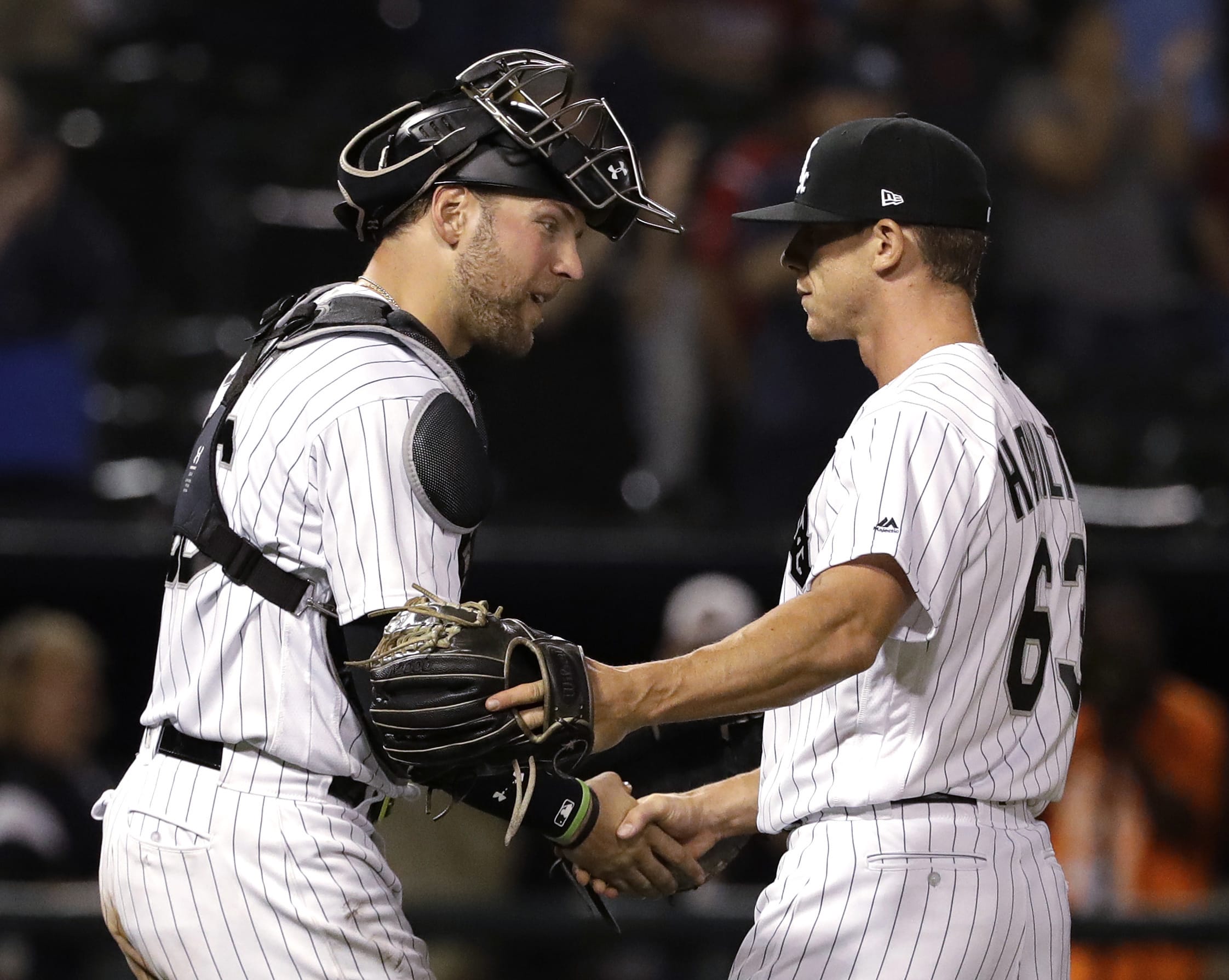 Chicago White Sox relief pitcher Ian Hamilton, right, celebrates with catcher Kevan Smith after the White Sox defeated the Boston Red Sox 6-1 in a baseball game, early Saturday, Sept. 1, 2018, in Chicago. Hamilton, a Skyview High grad, was making his major league debut. (AP Photo/Nam Y.