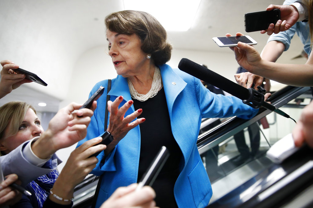 Sen. Dianne Feinstein, D-Calif., is surrounded by reporters as she arrives for a vote, Tuesday, Sept. 18, 2018, on Capitol Hill in Washington.