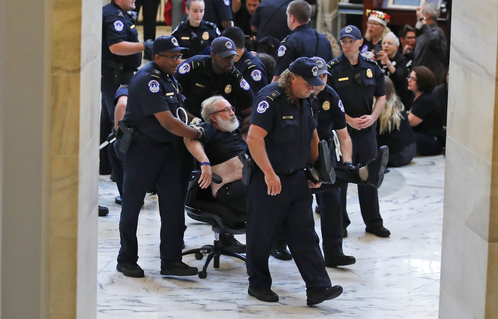 Capitol Hill Police use an office chair to wheel away a protester against Judge Brett Kavanaugh in the Russell Senate Office Building Rotunda, on Capitol Hill, Monday, Sept. 24, 2018 in Washington. A second allegation of sexual misconduct has emerged against Judge Brett Kavanaugh, a development that has further imperiled his nomination to the Supreme Court, forced the White House and Senate Republicans onto the defensive and fueled calls from Democrats to postpone further action on his confirmation. President Donald Trump is so far standing by his nominee.