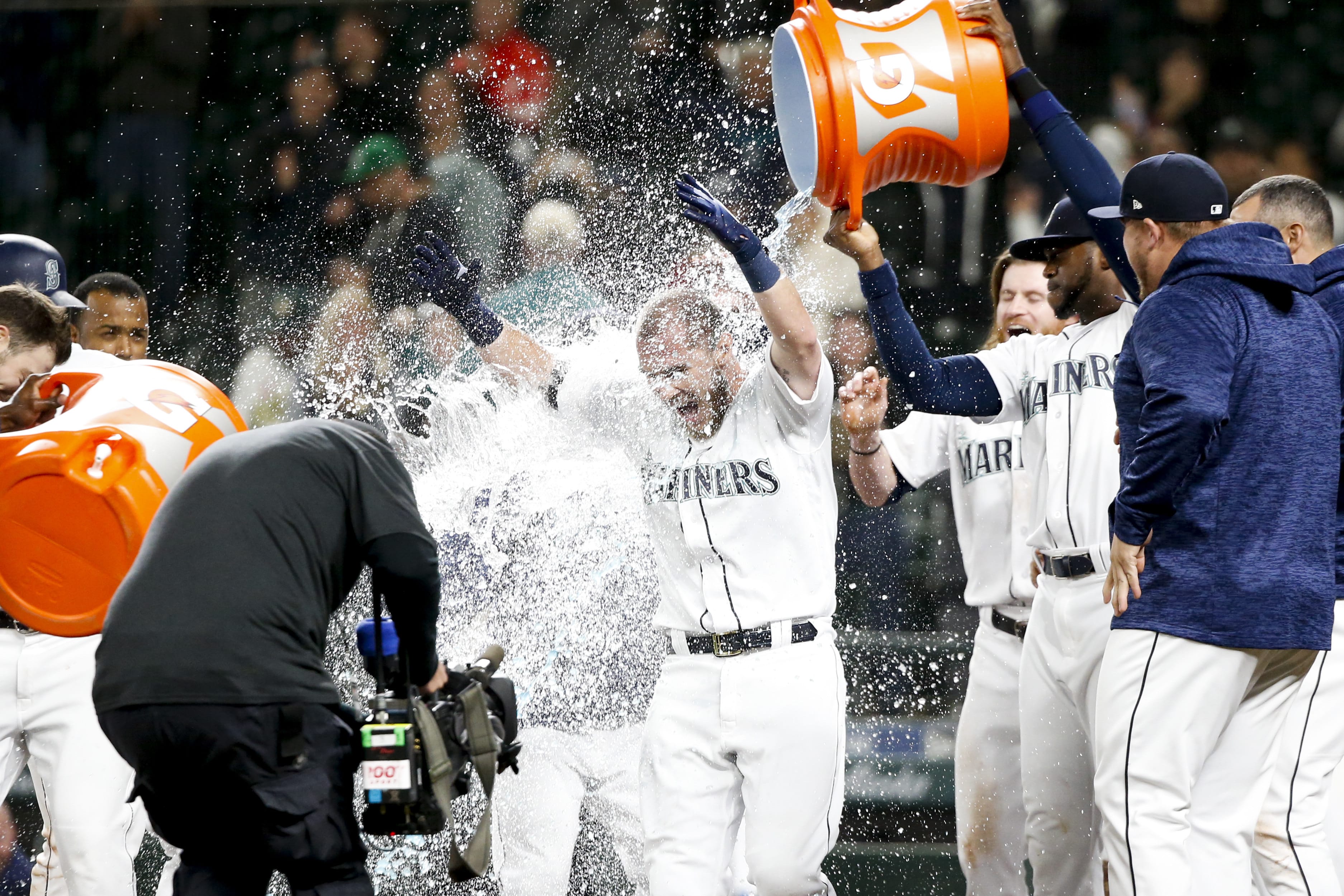 Seattle Mariners' Chris Herrmann gets a Gatorade shower after hitting a walk-off two-run home run against the Oakland Athletics during the eleventh inning of a baseball game Tuesday, Sept. 25, 2018, in Seattle. Seattle won 10-8.
