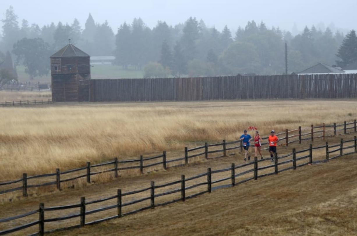 Rain soaks runners navigating Fort Vancouver during the inaugural Apple Tree Marathon in Vancouver on Sunday, September 16, 2018.
