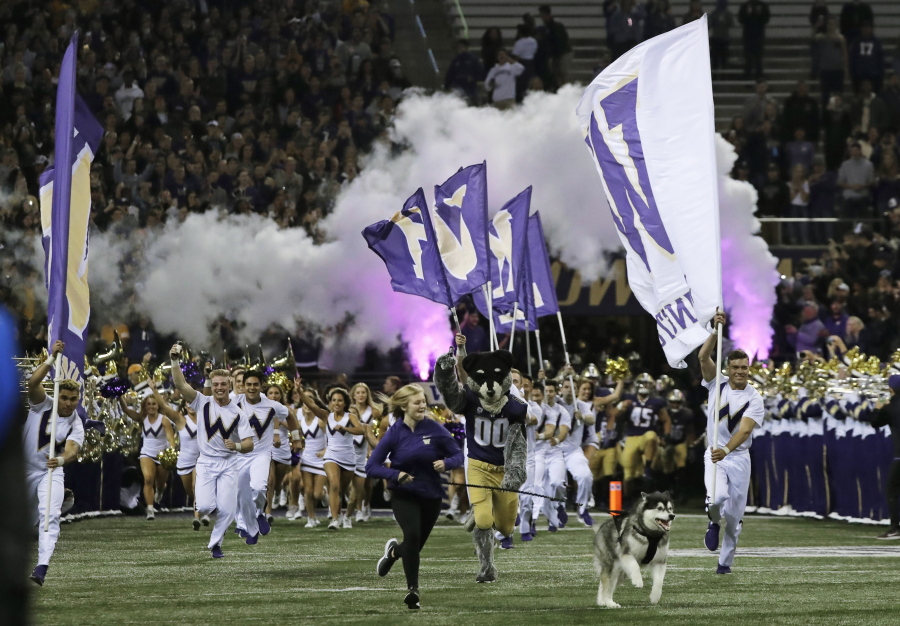 Dubs II, the Washington Huskies live mascot, leads the team out of the tunnel for an NCAA college football game against Arizona State, Saturday, Sept. 22, 2018, in Seattle. (AP Photo/Ted S.