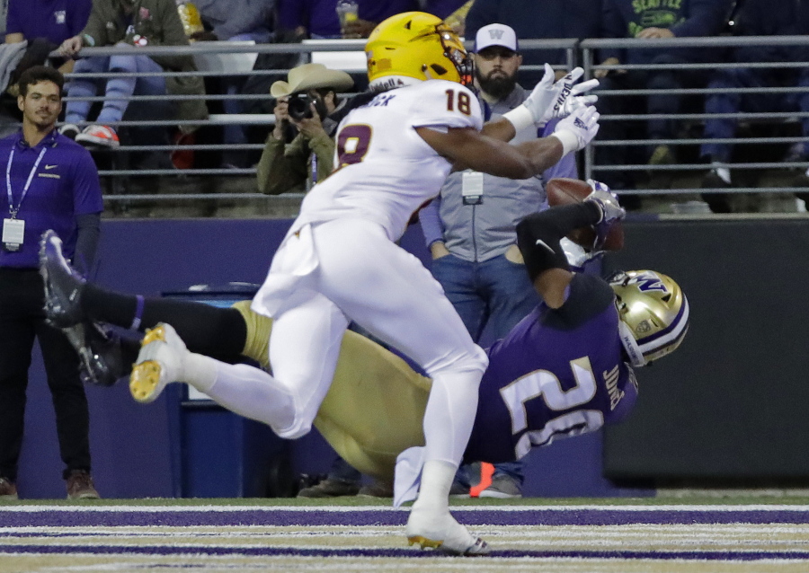 Washington wide receiver Ty Jones falls backward as he catches a pass for a touchdown, while Arizona State cornerback Langston Frederick (18) defends during the first half of an NCAA college football game, Saturday, Sept. 22, 2018, in Seattle. (AP Photo/Ted S.