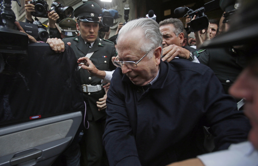 Fernando Karadima is escorted from a court, after testifying in a case that three of his victims brought against the country’s Catholic Church in Santiago, Chile. Pope Francis has on Friday, Sept. 29, 2018, defrocked Karadima, a priest at the center of the global sex abuse scandal rocking his papacy, invoking his “supreme” authority to stiffen a sentence originally handed down by a Vatican court in 2011.