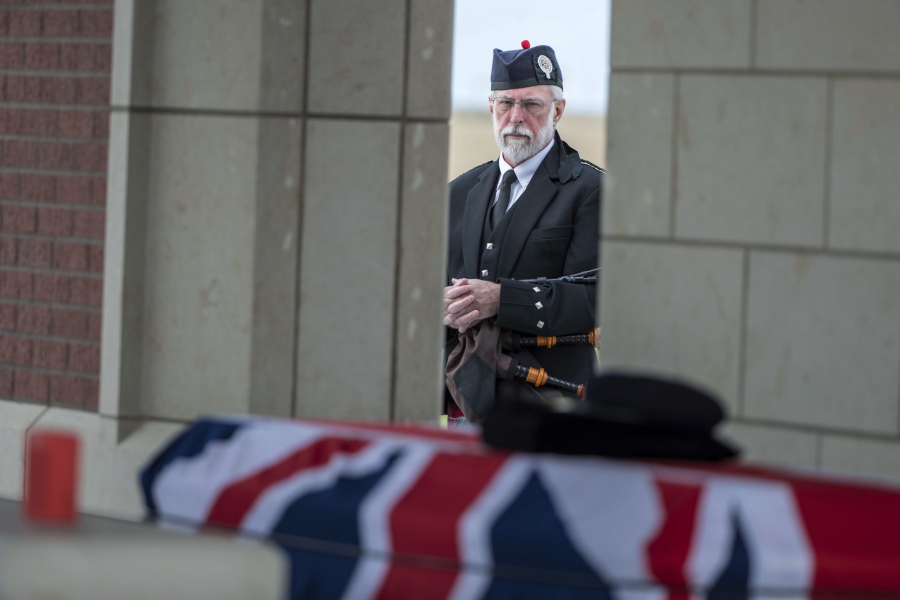 Bagpiper Malcolm WIlbur waits to play Amazing Grace for the funeral of Jean Watters at the Omaha National Cemetery in Omaha, Neb. Jean Watters was part of the super-secret team that broke the German ENIGMA code during World War II.