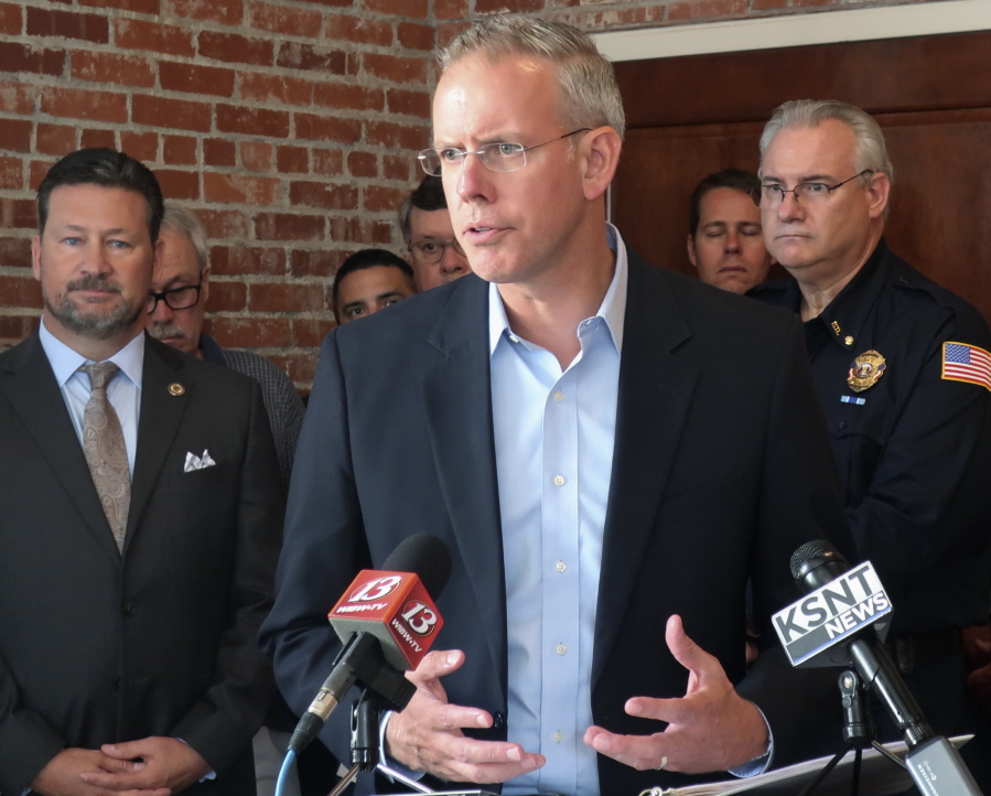 In this Aug. 24, 2018, photo, Paul Davis, the Democratic nominee in the 2nd Congressional District of eastern Kansas, answers questions during a news conference with representatives and public safety groups that have endorsed him, in Topeka, Kan. Davis has distanced himself from House Democratic Leader Nancy Pelosi but Republicans are nonetheless trying to tie him to her.