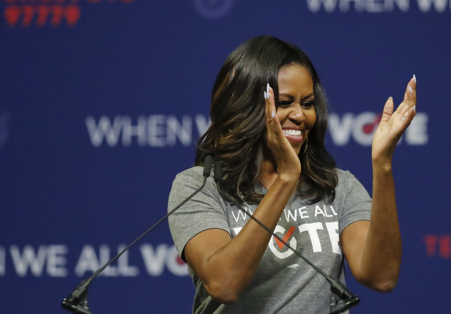 Former first lady Michelle Obama claps during a rally to encourage voter registration Friday in Coral Gables, Fla.
