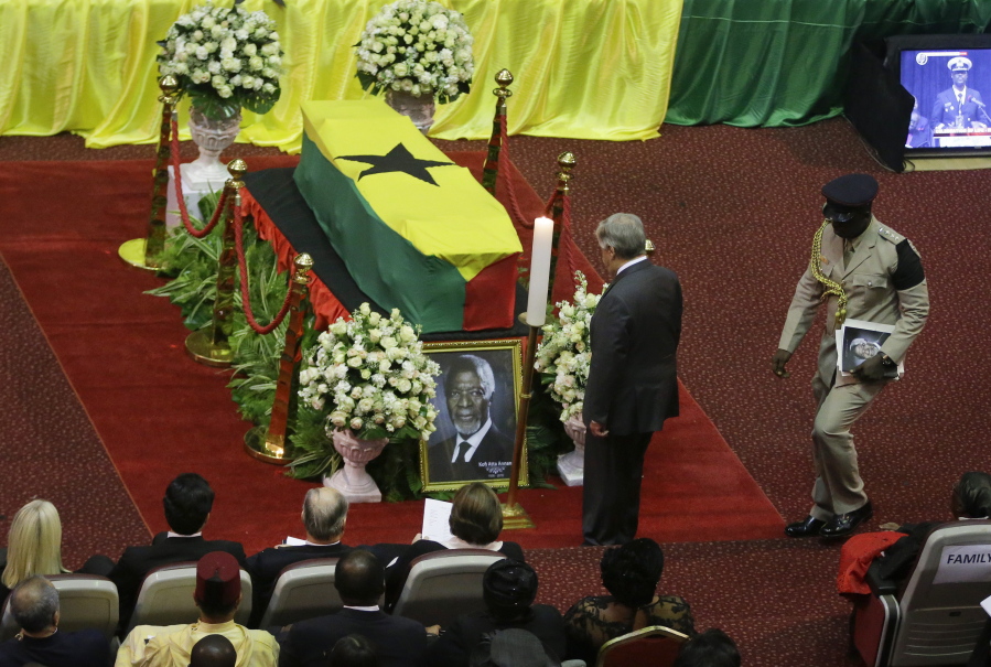 Current U.N. Secretary-General Antonio Guterres, center, pays his respects by the coffin of former U.N. Secretary-General Kofi Annan, draped with the Ghana flag, during a state funeral at the Accra International Conference Center in Ghana Thursday, Sept. 13, 2018. After days of lying in state for mourners to pay their respects the body of Kofi Annan, who died in August in Switzerland at age 80, will be buried Thursday after a final funeral ceremony.