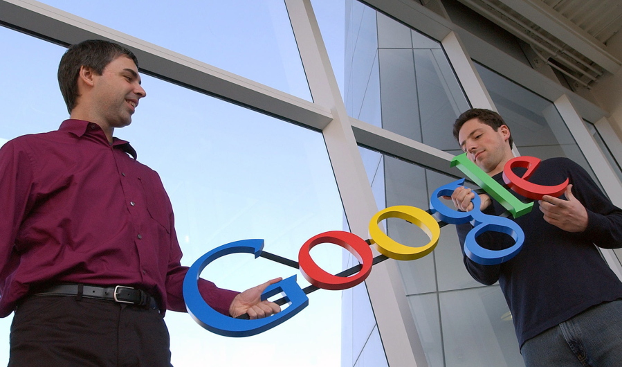 FILE- In this Jan. 15, 2004, file photo Google co-founders Larry Page, left, and Sergey Brin pose for a photo at their company’s headquarters in Mountain View, Calif. Twenty years after Page and Brin set out to organize all of the internet’s information, the search engine they named Google has morphed into a dominating force in smartphones, online video, email, maps and much more.