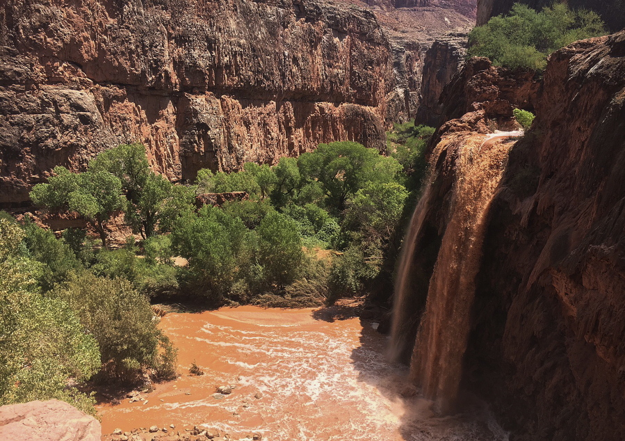 Water normally blue-green is turned muddy brown after flooding July 11 in Supai, Ariz.