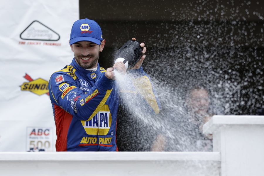 Alexander Rossi celebrates in Victory Lane after winning the IndyCar auto race at Pocono Raceway, Sunday, Aug. 19, 2018, in Long Pond, Pa.