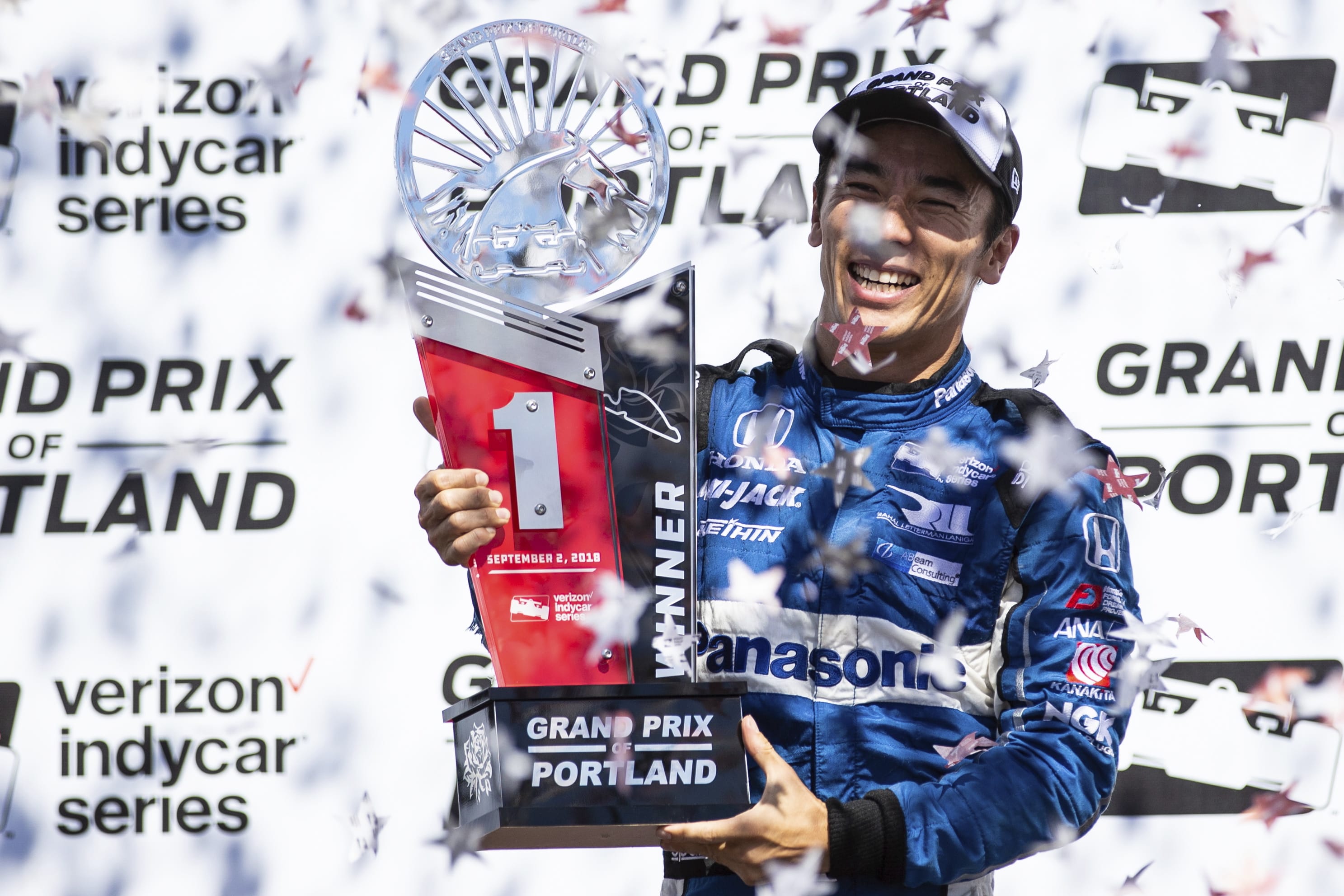 Takuma Sato celebrates his first-place finish at an IndyCar auto race, Sunday, Sept. 2, 2018, in Portland, Ore.