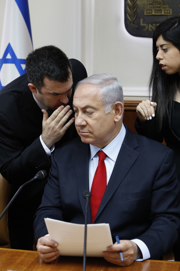 Israeli Prime Minister Benjamin Netanyahu listens, July 23, to his spokesman David Keyes as he opens the weekly cabinet meeting at his Jerusalem office.