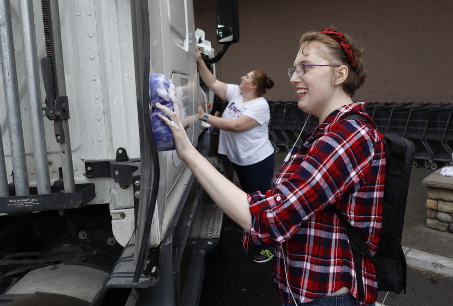 Jade Samples, right, and her mother, Angie Bolster, wash a large truck at a car wash fundraiser for Samples, a Vancouver teen in need of a lifesaving kidney transplant. Samples was diagnosed with Lupus last year, and has encountered a series of medical problems that have delayed her kidney transplant.