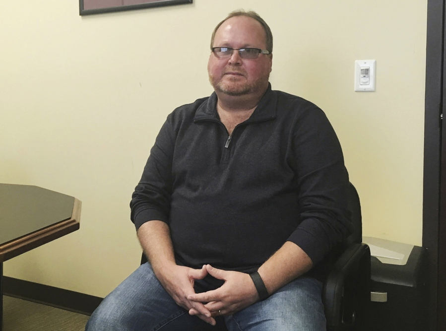 Elwood Caudill Jr. sits at the Rowan County Property Valuation Administrators office in Morehead, Ky. Caudill won the Democratic nomination in May 2018 to face Republican Rowan County Clerk Kim Davis in the November election. Caudill defeated David Ermold, a gay man who was denied a marriage license by Davis in 2015.