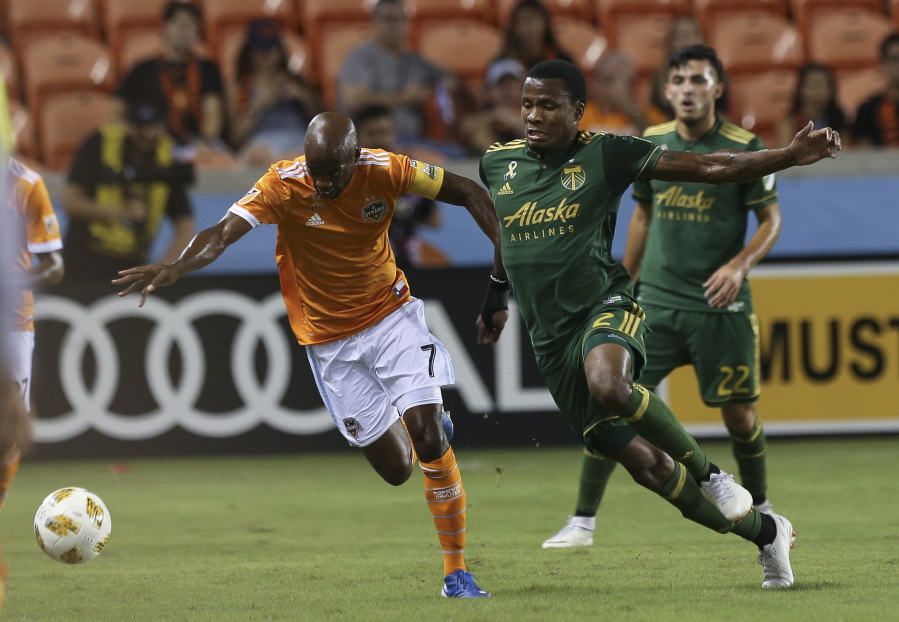 Houston Dynamo defender DaMarcus Beasley (7) and Portland Timbers defender Alvas Powell (2) battle for possession of the ball during the first half of the MLS soccer game at BBVA Compass Stadium on Saturday, Sept. 15, 2018, in Houston.