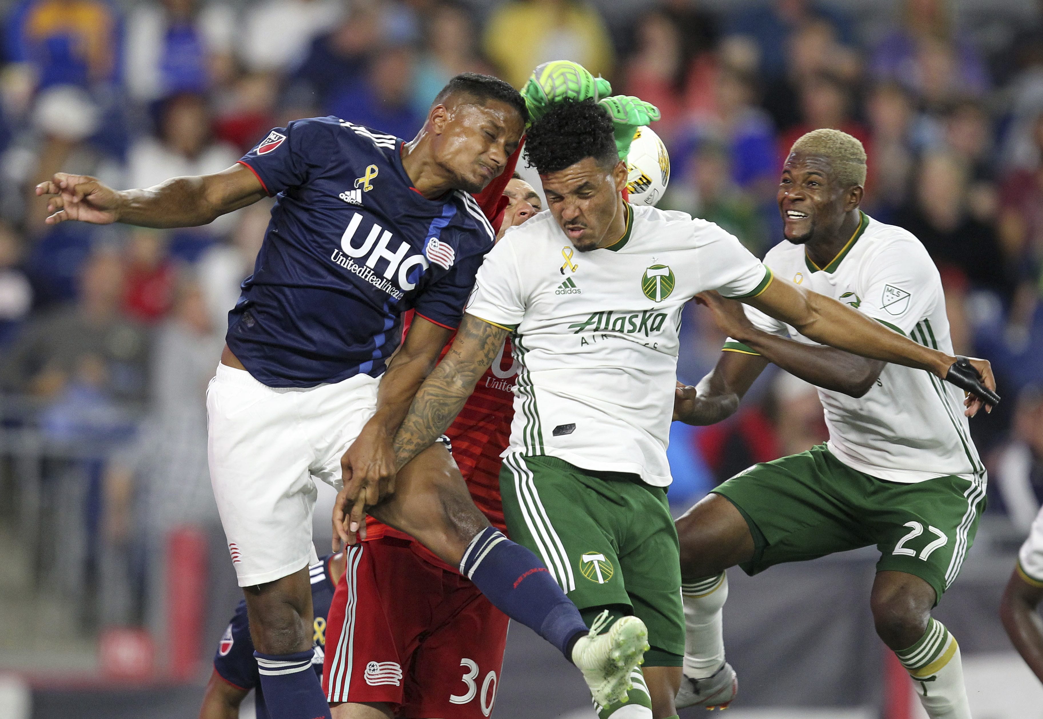 New England Revolution defender Michael Mancienne, left and New England Revolution goalkeeper Matt Turner (30) defend a corner kick as Portland Timbers defender Julio Cascante, second left, and midfielder Dairon Asprilla (27) attack during the second half of an MLS soccer match in Foxborough, Mass., Saturday, Sept. 1, 2018.