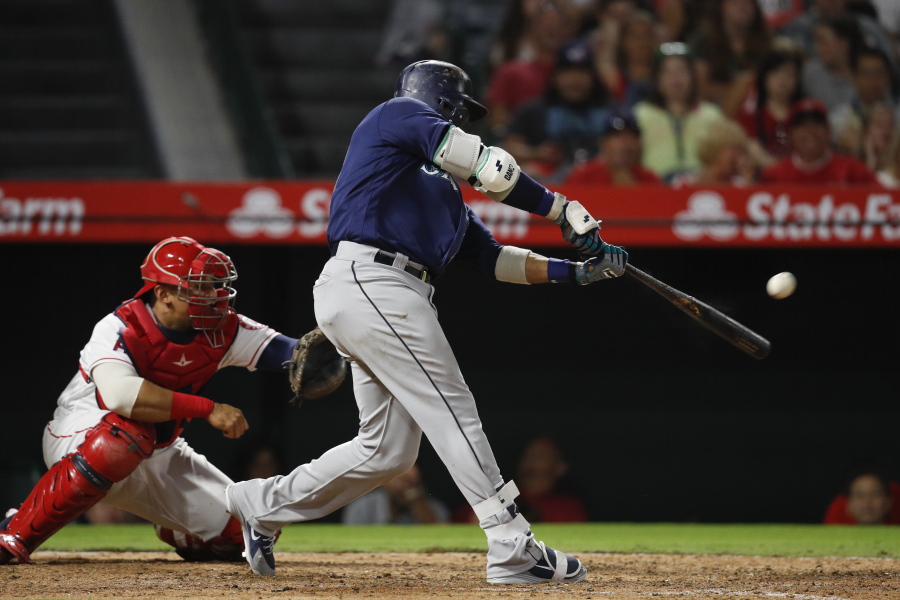 Seattle Mariners’ Robinson Cano connects for a three-run double during the eighth inning of a baseball game against the Los Angeles Angels, Saturday, Sept. 15, 2018, in Anaheim, Calif. (AP Photo/Jae C.