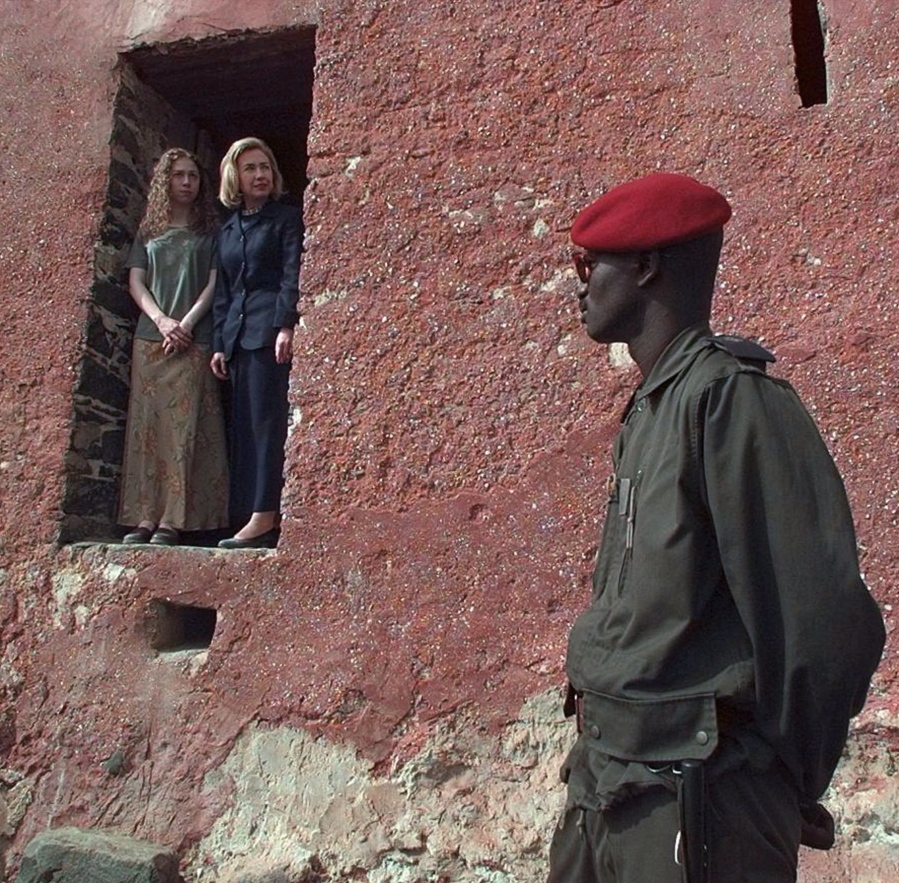 FILE - In this March 17, 1997, file photo, as a Senegalese guard looks on, first lady Hillary Rodham Clinton and daughter Chelsea look out from “the door of no return” on Goree Island in Dakar, Senegal. This is the door through which more than 60,000 slaves walked before being shipped to the west and used as slaves. Mrs. Clinton is on the first day of her two-week goodwill tour through Africa. When Melania Trump flies to Africa on her first extended international journey without the president, she’ll be following in the footsteps of her recent predecessors.