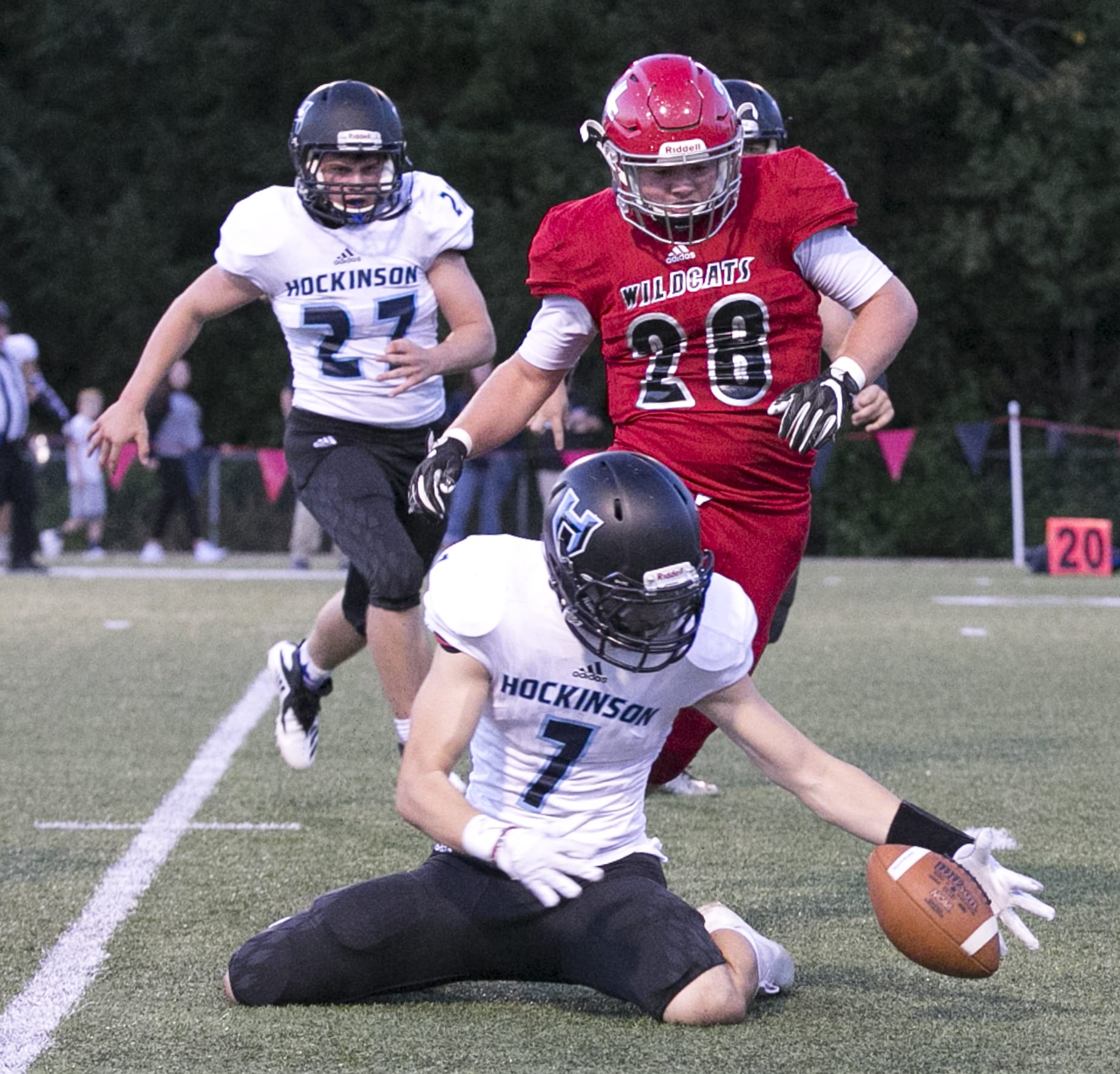 Hockinson's Nick Charles (bottom) works to gather a blocked punts with Archbishop Murphy's Evan Thode (28) trailing Thursday night at Archbishop Murphy High School in Everett on September 6, 2018.