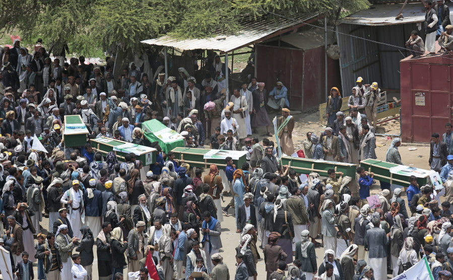 FILE - In this Aug. 13, 2018 file photo, Yemeni people carry the coffins of victims of a Saudi-led airstrike, during a funeral in Saada, Yemen. Secretary of State Mike Pompeo says he has told Congress the governments of Saudi Arabia and the United Arab Emirates are trying to protect civilians amid their military operations to end the civil war in Yemen. Pompeo said in a statement Wednesday he certified to Congress a day earlier the Saudi and Emirati governments “are undertaking demonstrable actions to reduce the risk of harm to civilians and civilian infrastructure.” Defense Secretary Jim Mattis says he endorses Pompeo’s certification.