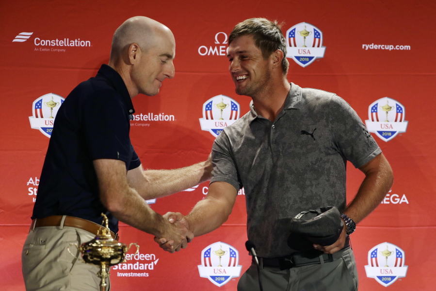 Jim Furyk, left, U.S. Ryder Cup Team Captain, greets Bryson DeChambeau, a captain’s pick for the 2018 team, during a news conference, Tuesday, Sept. 4, 2018, in West Conshohocken, Pa.