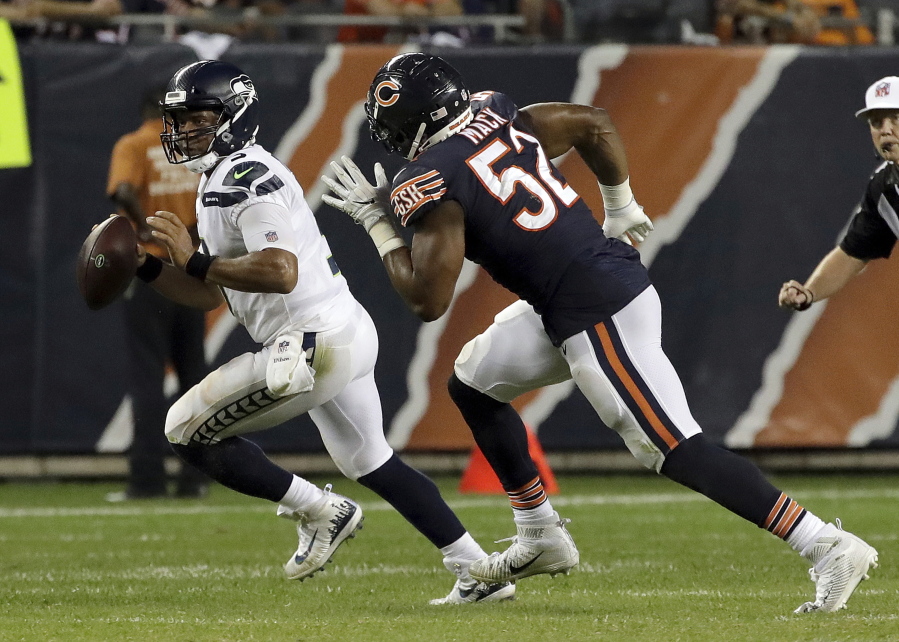 Chicago Bears linebacker Khalil Mack (52) chases Seattle Seahawks quarterback Russell Wilson (3) during the second half of an NFL football game Monday, Sept. 17, 2018, in Chicago. (AP Photo/Nam Y.