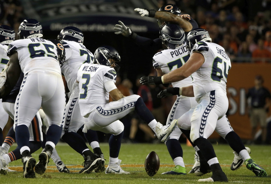 Seattle Seahawks quarterback Russell Wilson (3) loses a ball during the first half of an NFL football game against the Chicago Bears Monday, Sept. 17, 2018, in Chicago.