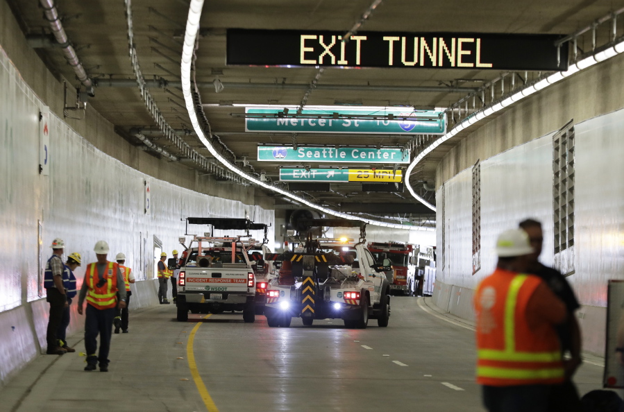 A tow truck backs up near emergency vehicles, Thursday, Sept. 27, 2018, following an emergency drill inside the tunnel that will eventually replace the Alaskan Way Viaduct in Seattle. Multiple federal, state, and local agencies conducted the drill Thursday ahead of the tunnel’s planned opening in 2019. The drill included a staged multi-vehicle crash, volunteers simulating injured travelers, emergency response crews and activation of the tunnel’s deluge fire suppression system. (AP Photo/Ted S.
