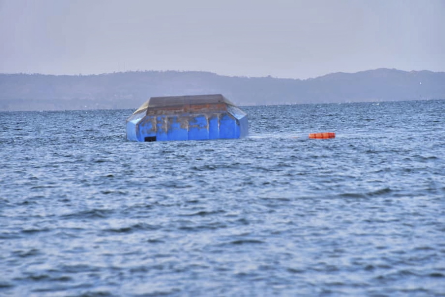 The overturned passenger ferry MV Nyerere floats Friday near Ukara Island in Lake Victoria, Tanzania.