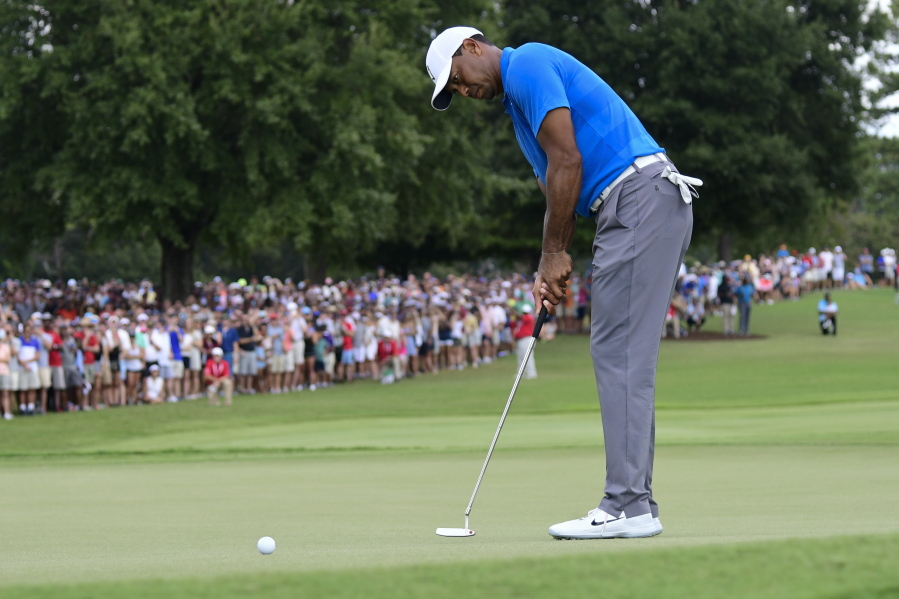 Tiger Woods putts for birdie on the third hole during the third round of the Tour Championship golf tournament Saturday, Sept. 22, 2018, in Atlanta.